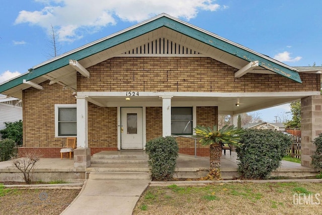 view of front of property with a porch and brick siding