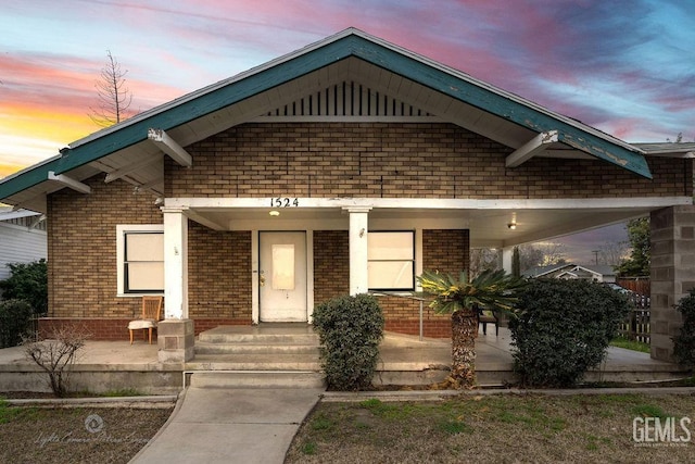 view of front of property with a porch and brick siding