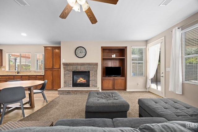 9221 Via Lugano, Bakersfield, CA 93312 - living room featuring healthy amount of natural light, a fireplace, and built in shelves
