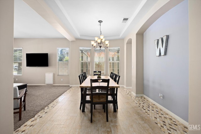 9221 Via Lugano, Bakersfield, CA 93312 - dining area featuring a chandelier, healthy amount of natural light, a raised ceiling, and baseboards