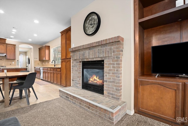 9221 Via Lugano, Bakersfield, CA 93312 - living room featuring a brick fireplace, recessed lighting, and arched walkways