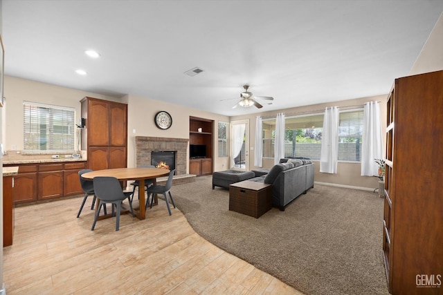 9221 Via Lugano, Bakersfield, CA 93312 - living area with a fireplace, a ceiling fan, healthy amount of natural light, light wood-style flooring, and recessed lighting
