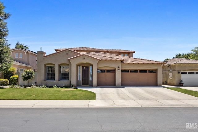 9221 Via Lugano, Bakersfield, CA 93312 - mediterranean / spanish house with a garage, stucco siding, concrete driveway, a front lawn, and a tile roof