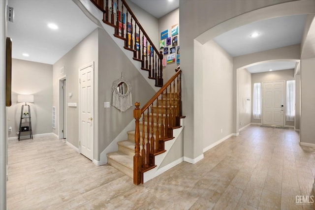 9221 Via Lugano, Bakersfield, CA 93312 - foyer entrance featuring arched walkways, light wood finished floors, baseboards, stairway, and recessed lighting