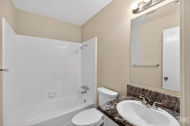 1929 Belmont St, Delano, CA 93215 - bathroom with toilet, vanity, shower / bathtub combination, and a textured wall