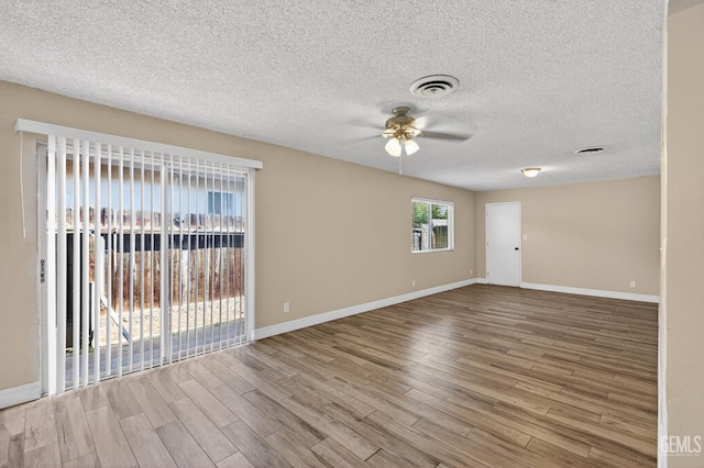 1929 Belmont St, Delano, CA 93215 - empty room with ceiling fan, wood finished floors, baseboards, and a textured ceiling