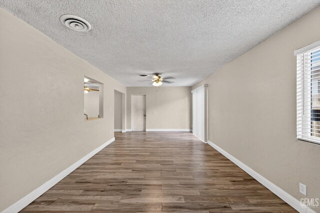 1929 Belmont St, Delano, CA 93215 - spare room with a textured ceiling, a ceiling fan, wood finished floors, and baseboards
