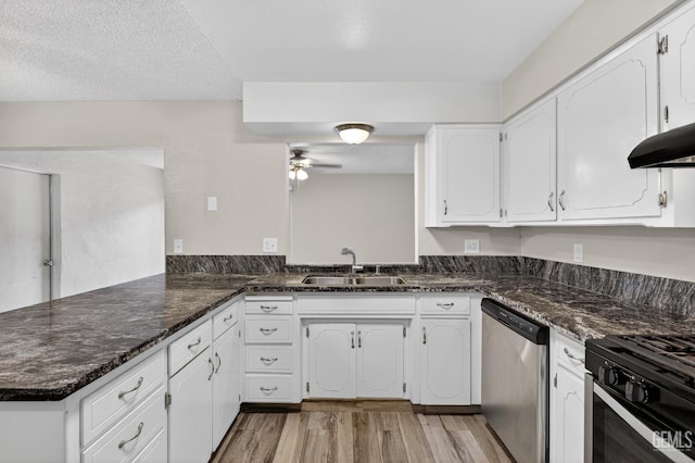 1929 Belmont St, Delano, CA 93215 - kitchen with dishwasher, a sink, ceiling fan, a peninsula, and white cabinetry