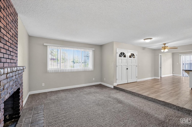 1929 Belmont St, Delano, CA 93215 - unfurnished living room with a brick fireplace, ceiling fan, a textured ceiling, carpet, and baseboards