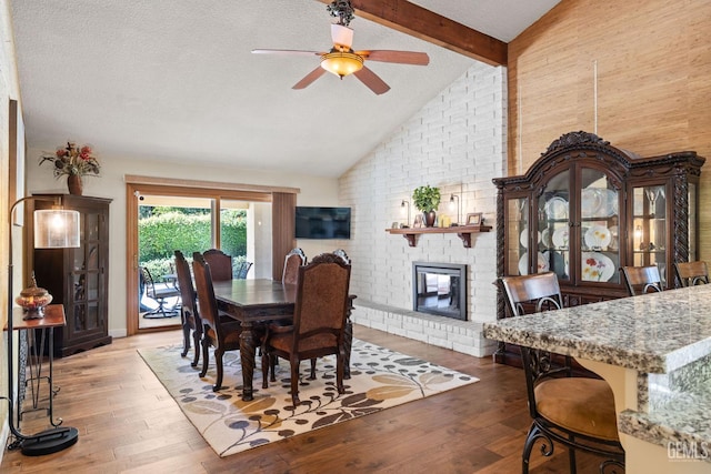 601 Vista Verde Way, Bakersfield, CA 93309 - dining room featuring wood finished floors, a fireplace, beamed ceiling, a ceiling fan, and a textured ceiling
