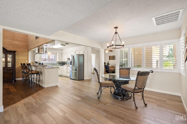 601 Vista Verde Way, Bakersfield, CA 93309 - dining room with a chandelier, a textured ceiling, and light wood-style floors