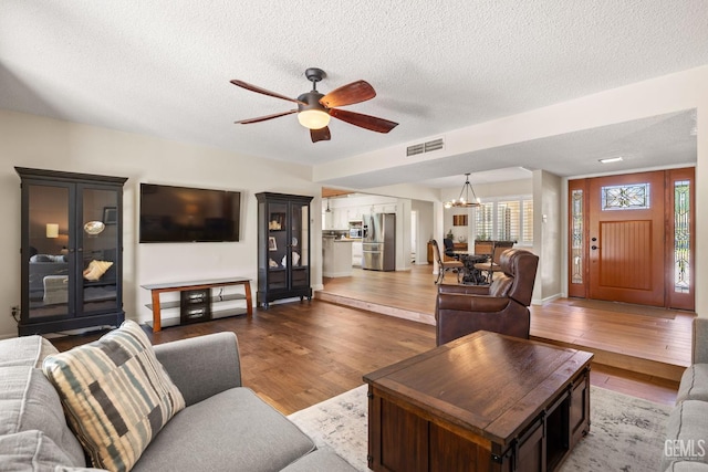 601 Vista Verde Way, Bakersfield, CA 93309 - living area featuring a ceiling fan, wood finished floors, a chandelier, and a textured ceiling