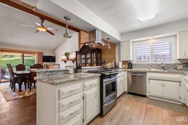 601 Vista Verde Way, Bakersfield, CA 93309 - kitchen with stainless steel appliances, island exhaust hood, a peninsula, light wood-style floors, and light stone countertops