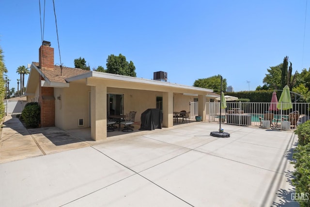 601 Vista Verde Way, Bakersfield, CA 93309 - back of house featuring stucco siding, a patio, and a chimney