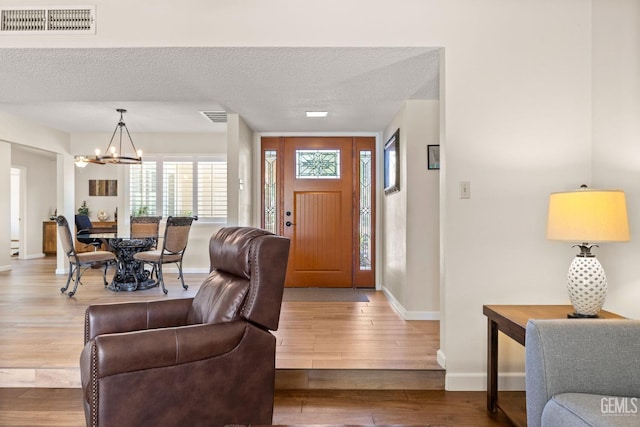 601 Vista Verde Way, Bakersfield, CA 93309 - foyer entrance with a chandelier, wood finished floors, and a textured ceiling