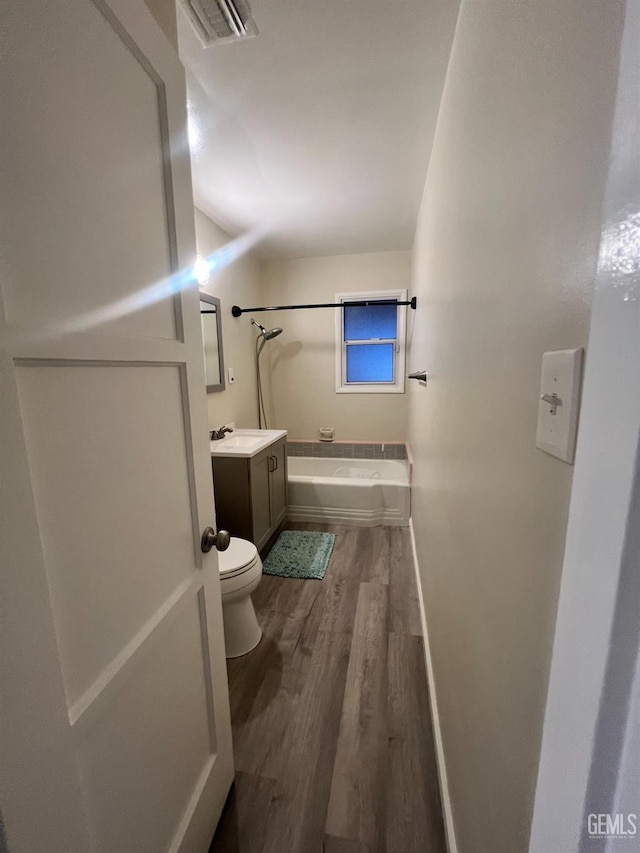 full bathroom with vanity,  shower combination, toilet, and wood-type flooring