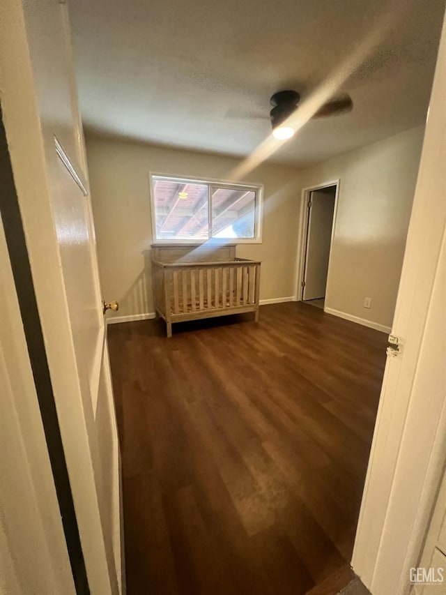 bonus room featuring ceiling fan and dark hardwood / wood-style flooring