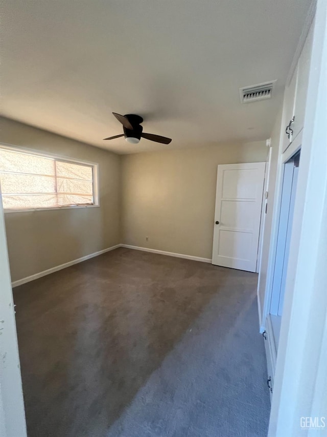 carpeted empty room with ceiling fan