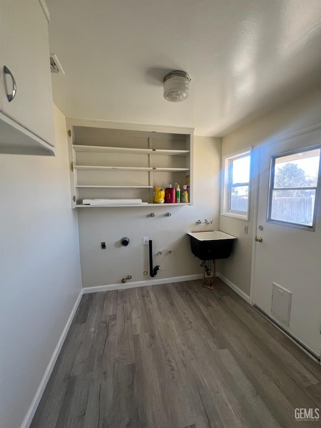 clothes washing area featuring hookup for an electric dryer, dark hardwood / wood-style floors, and gas dryer hookup