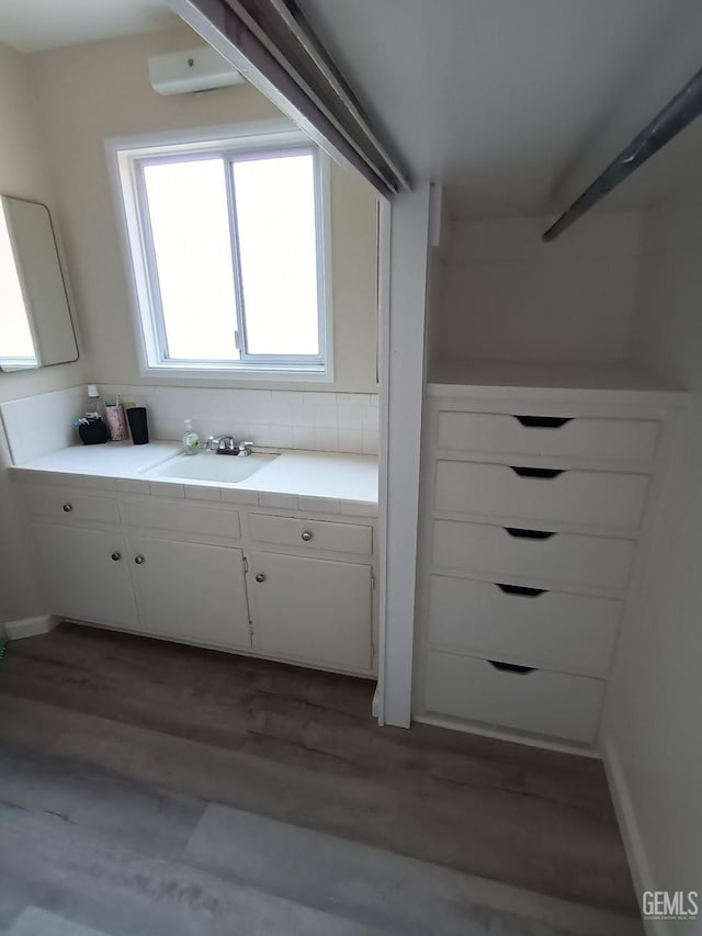 interior space featuring vanity and hardwood / wood-style flooring