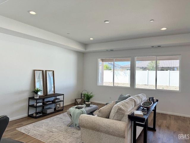 living area with recessed lighting, baseboards, and wood finished floors