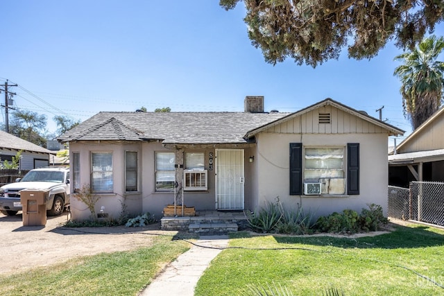 bungalow-style home with a front lawn