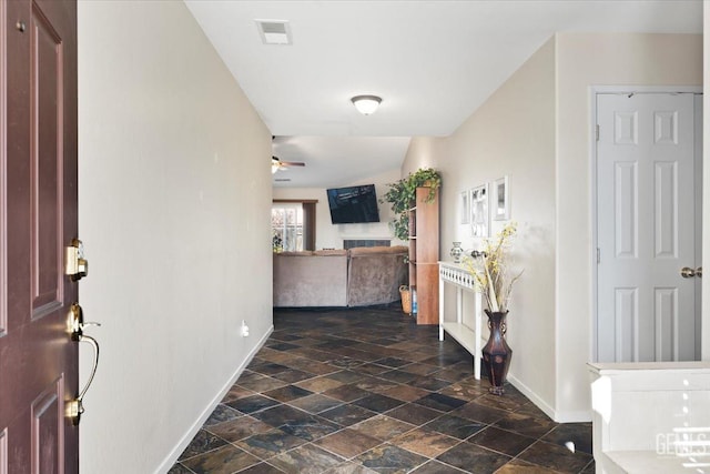 interior space with ceiling fan