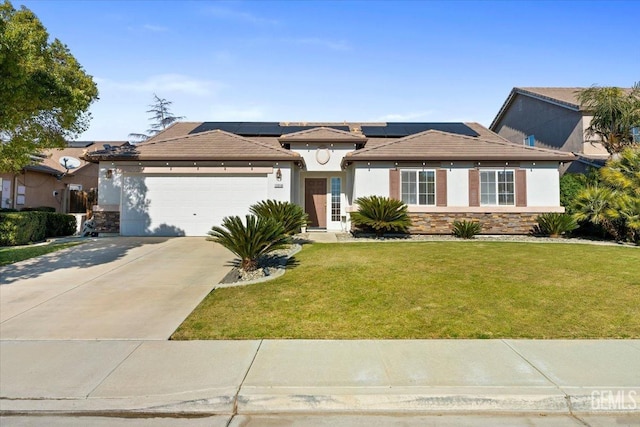 prairie-style house with a front lawn, a garage, and solar panels