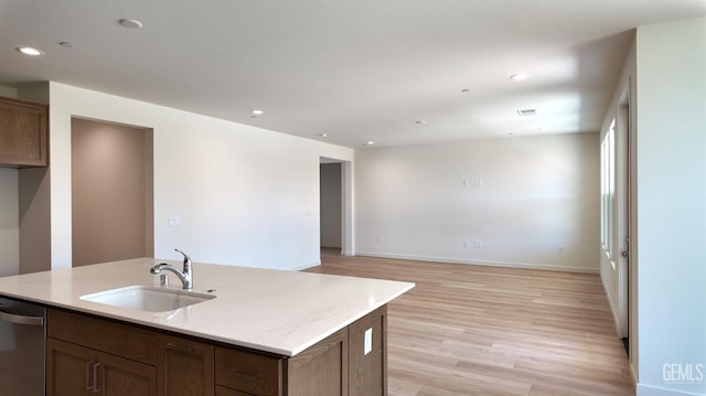 16903 Mairs Dr, Bakersfield, CA 93314 - kitchen with dishwasher, light wood-style flooring, recessed lighting, light stone countertops, and a kitchen island with sink