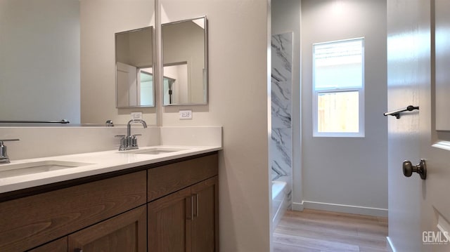 16903 Mairs Dr, Bakersfield, CA 93314 - bathroom featuring double vanity, wood finished floors, and tub / shower combination