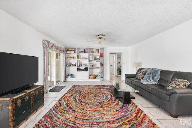 living room with light tile patterned floors, a ceiling fan, washer / clothes dryer, and a textured ceiling