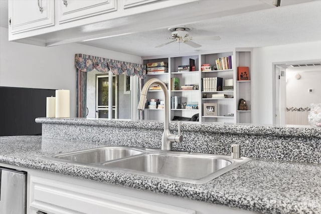 room details featuring ceiling fan, light stone counters, a sink, visible vents, and white cabinetry