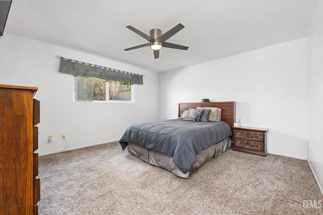 carpeted bedroom featuring a textured ceiling and ceiling fan