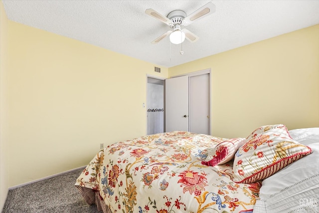 bedroom featuring carpet, a closet, visible vents, ceiling fan, and a textured ceiling