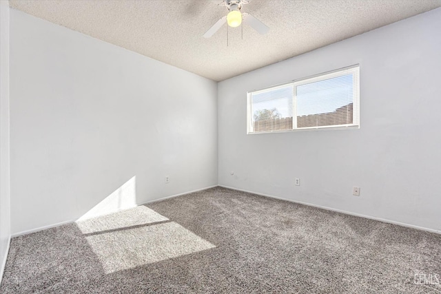 carpeted spare room with a textured ceiling and a ceiling fan