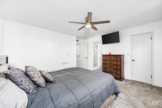 bedroom featuring a textured ceiling, visible vents, a ceiling fan, and light colored carpet