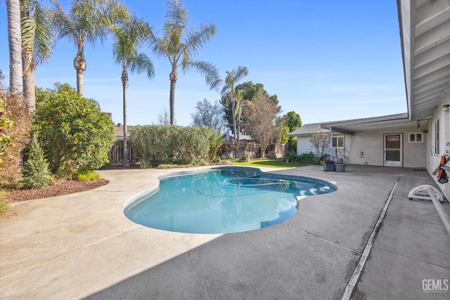 pool featuring a patio area and fence