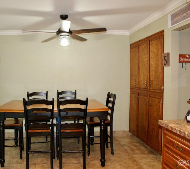 6813 Melones Ct, Bakersfield, CA 93309 - dining room featuring a ceiling fan, crown molding, and light tile patterned flooring