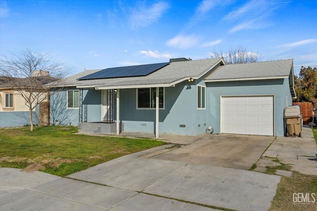 single story home with a garage, a front yard, and solar panels