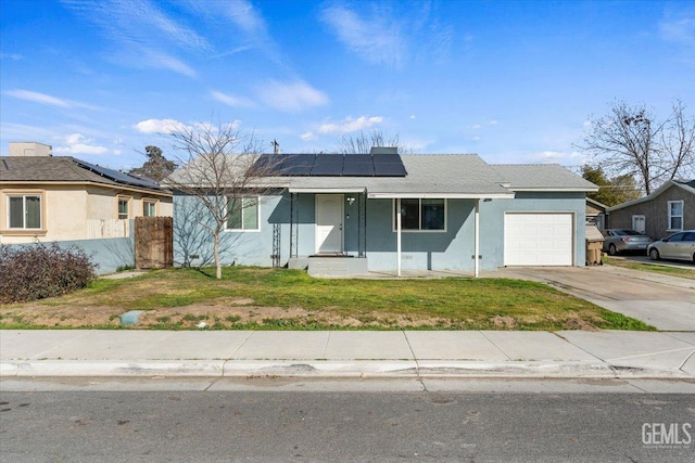 single story home featuring a garage, a front yard, and solar panels