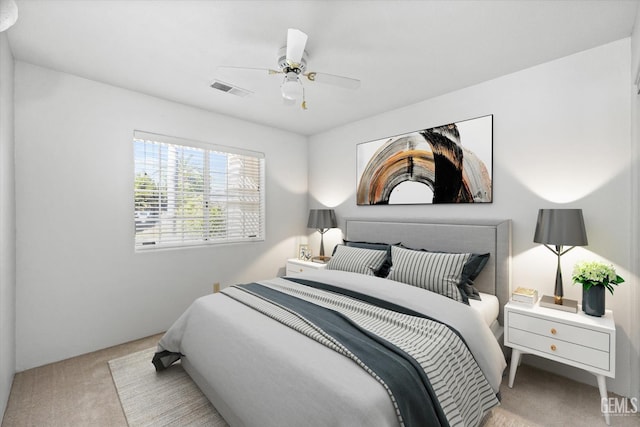 bedroom with ceiling fan and light carpet