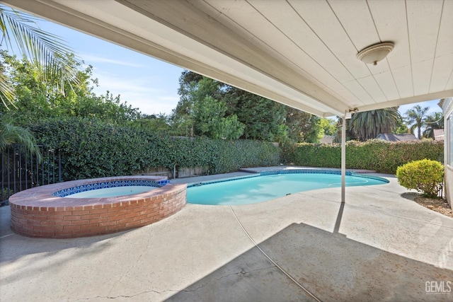 view of swimming pool with an in ground hot tub and a patio area