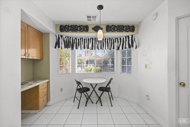 dining space with light tile patterned floors