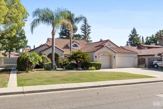 mediterranean / spanish-style house with a garage and a front lawn