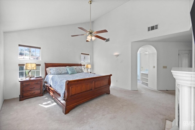 bedroom featuring ceiling fan, high vaulted ceiling, and light colored carpet