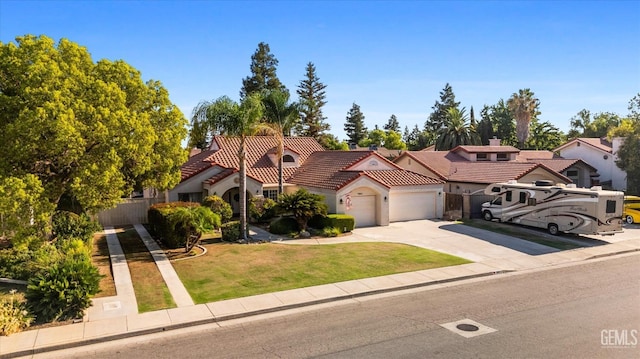 mediterranean / spanish home featuring a front lawn and a garage