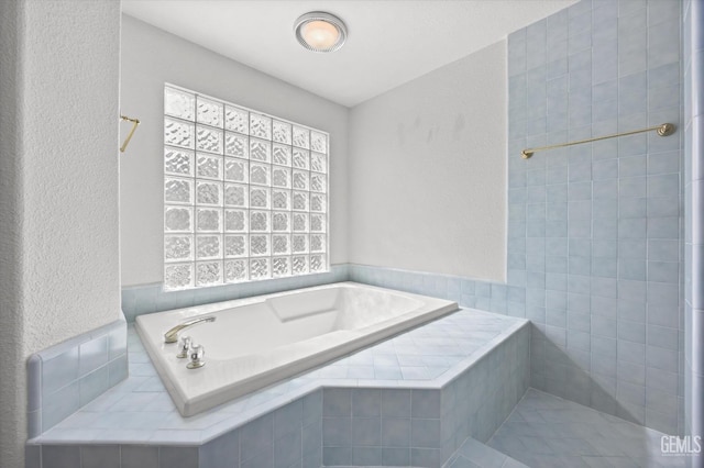 bathroom with tiled bath