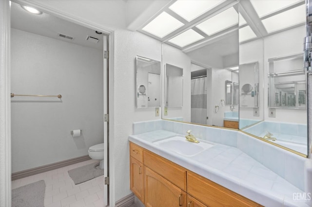 bathroom featuring tile patterned floors, vanity, and toilet