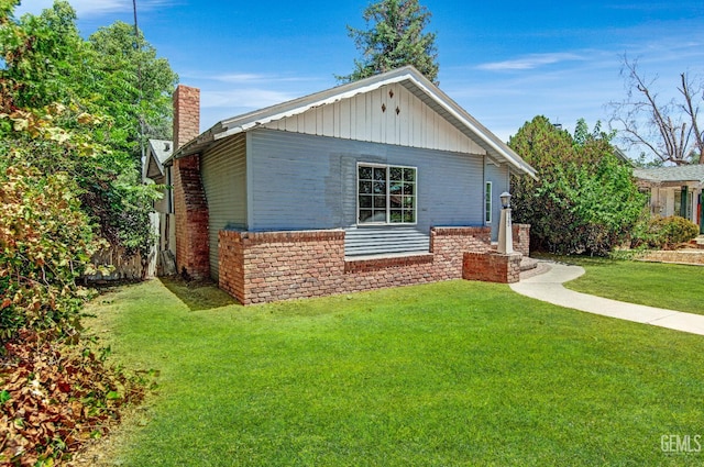 120 Pacific St, Bakersfield, CA 93305 - view of front of house featuring a front lawn and a chimney