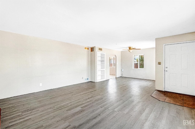 120 Pacific St, Bakersfield, CA 93305 - unfurnished living room with wood finished floors, a ceiling fan, and arched walkways